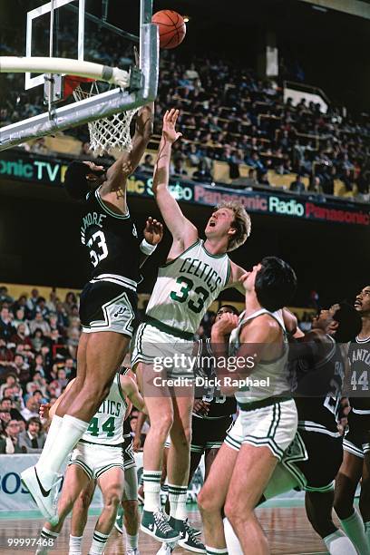 Larry Bird of the Boston Celtics shoots a layup against Artis Gilmore of the San Antonio Spurs during a game played in 1983 at the Boston Garden in...