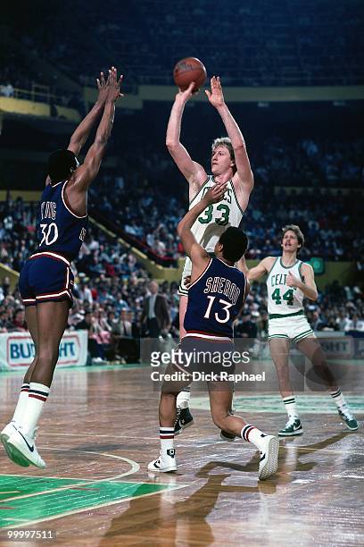 Larry Bird of the Boston Celtics shoots a jumper against Bernard King of the New York Knicks during a game played in 1983 at the Boston Garden in...