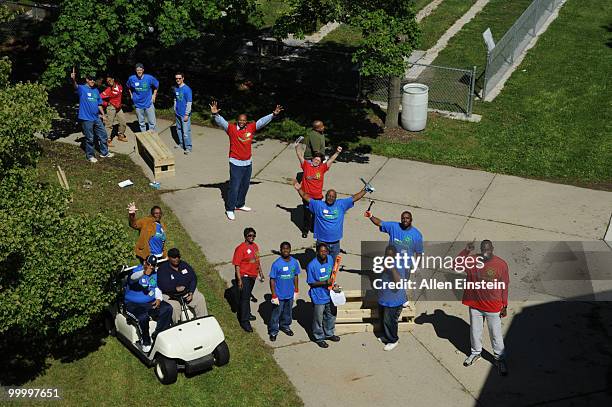Legends Derrick Colemen and Dikembe Mutombo join volunteers ready to begin work at the Leadership Detroit initiative during the 2010 Motor City...