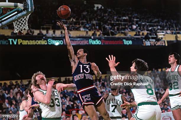 Ed Sherod of the New York Knicks shoots a layup against Larry Bird of the Boston Celtics during a game played in 1983 at the Boston Garden in Boston,...