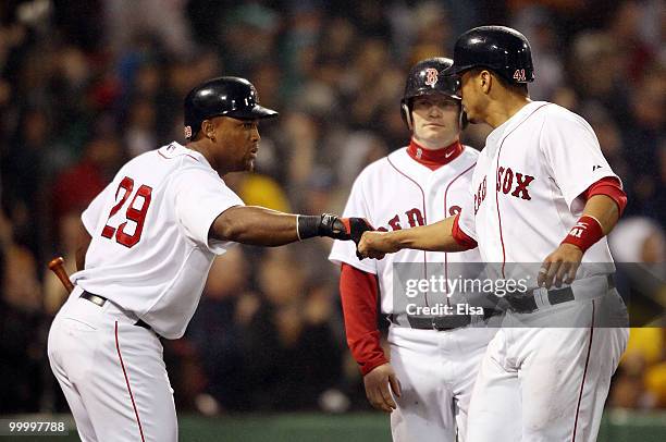 Adrian Beltre of the Boston Red Sox congratulates teammate Victor Martinez after Martinez scored in the fourth inning against the Minnesota Twins on...