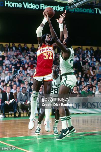 Dan Roundfield of the Atlanta Hawks goes up for a shot against Cedric Maxwell of the Boston Celtics during a game played in 1983 at the Boston Garden...