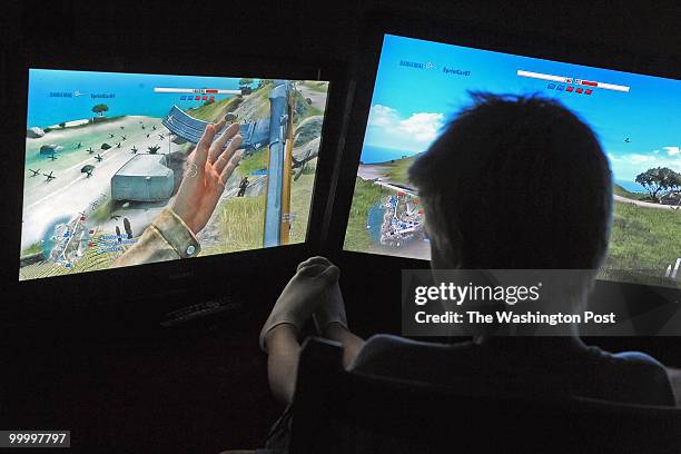 Leigh Mill Road, Great Falls, VA. SUMMARY: Mark Bulkeley and his two sons, Luke and Andrew, playing video games in a room in their house they call...