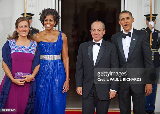 Mexican First Lady Margarita Zavala, US First Lady Michelle Obama, Mexican President Felipe Calderone, and US President Barack Obama turn to the...