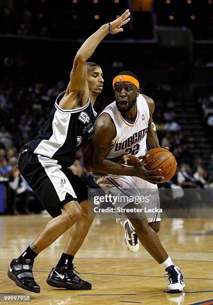 Ronald Murray of the Charlotte Bobcats drives to the basket past George Hill of the San Antonio Spurs during the game on January 15, 2010 at Time...