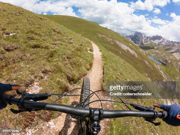 man mountain biking, fanes-sennes-braies national park, dolomites, trentino, south tyrol, italy - extreme sports point of view stock pictures, royalty-free photos & images