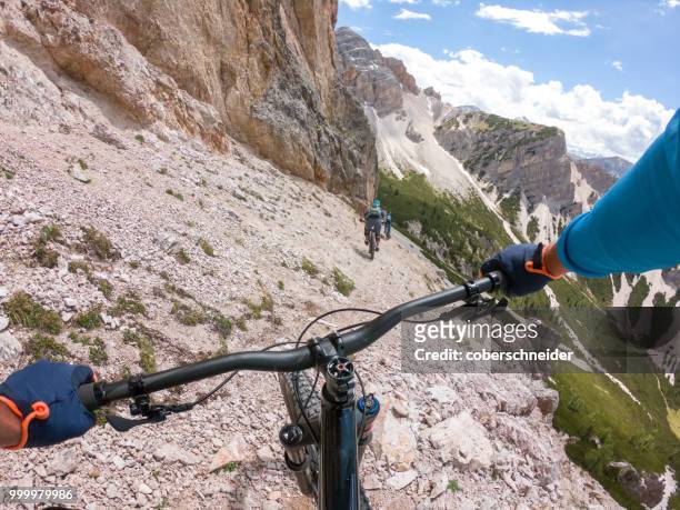 three men mountain biking, fanes-sennes-braies national park, dolomites, trentino, south tyrol, italy - extreme sports point of view stock pictures, royalty-free photos & images