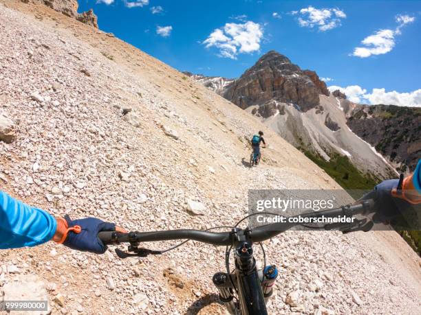 two men mountain biking, fanes-sennes-braies national park, dolomites, trentino, south tyrol, italy - extreme sports point of view stock pictures, royalty-free photos & images