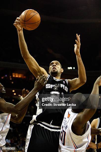 Tim Duncan of the San Antonio Spurs lays the ball up over Raymond Felton of the Charlotte Bobcats during the game on January 15, 2010 at Time Warner...