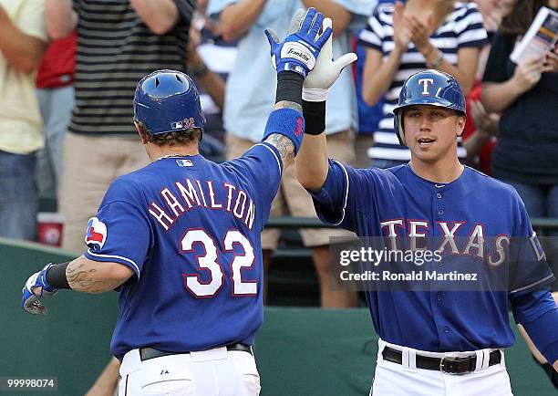 Josh Hamilton of the Texas Rangers celebrates a homerun with Justin Smoak against the Baltimore Orioles on May 19, 2010 at Rangers Ballpark in...