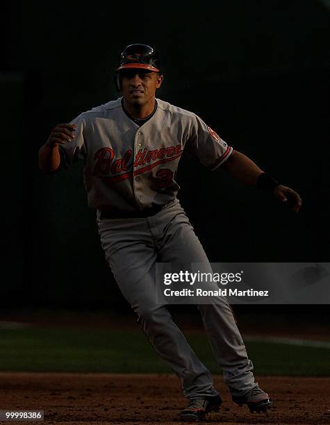 Cesar Izturis of the Baltimore Orioles leads off first base against the Texas Rangers on May 19, 2010 at Rangers Ballpark in Arlington, Texas.