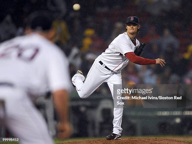 Clay Buchholz of the Boston Red Sox throws to Kevin Youkilis for a successful pick off at first base against the Minnesota Twins in the third inning...
