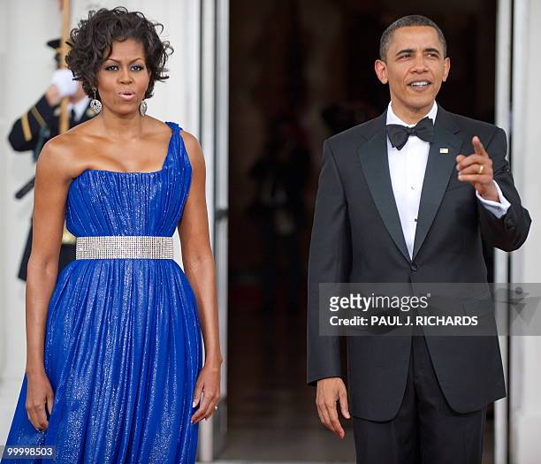 First Lady Michelle Obama and US President Barack Obama wait on the red carpet for the arrival of the Mexican President and his wife May 19, 2010 on...