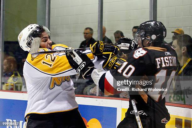 Travis Hamonic of the Brandon Wheat Kings body checks Misha Fisenko of the Calgary Hitmen during the 2010 Mastercard Memorial Cup Tournament at the...