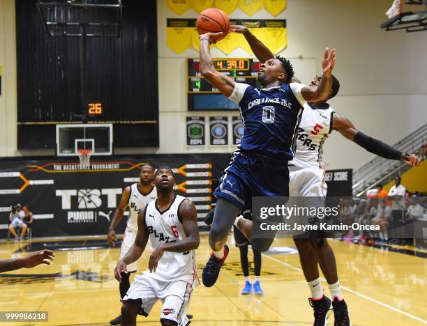 Franklin Robinson of the Citi Team Blazers defends a shot by E.J. Rowland of Team Challenge ALS in the Western Regional of The Basketball Tournament...