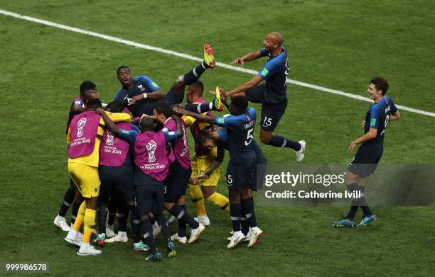 Paul Pogba of France jumps on his team mates as the celebrate after Kylian Mbappe of France scores his team's fourth goal during the 2018 FIFA World...