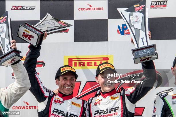 Scott Hargrove of Canada and Wolf Henzler of Germany celebrate after the Pirelli World Challenge GT race at Portland International Raceway on July...