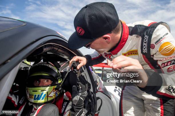 Scott Hargrove of Canada and Wolf Henzler of Germany talk after the Pirelli World Challenge GT race at Portland International Raceway on July 15,...