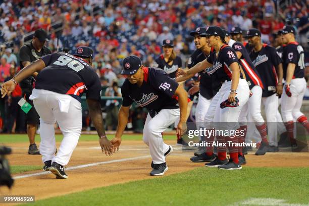 Players representing the American League celebrate during the Legends & Celebrity Softball Game at Nationals Park on Sunday, July 15, 2018 in...