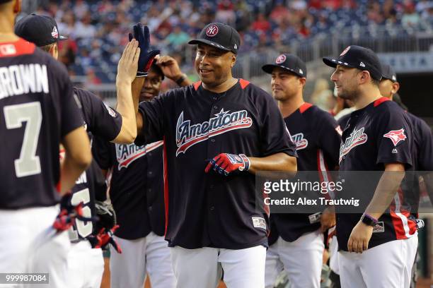 Bernie Williams celebrates with his teammates during the Legends & Celebrity Softball Game at Nationals Park on Sunday, July 15, 2018 in Washington,...