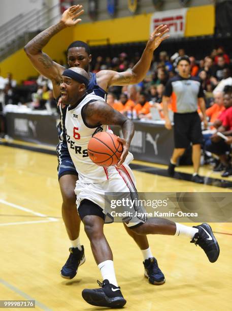 Ivan Asks of Team Challenge ALS guards Bobby Brown of the Citi Team Blazers as he drives to the basket during the Western Regional of The Basketball...