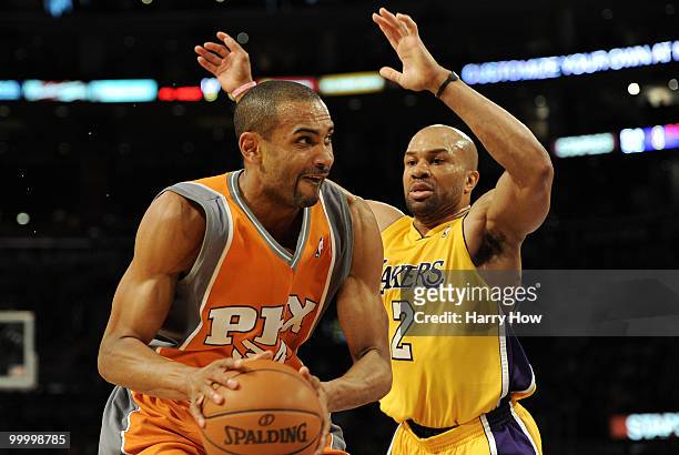 Grant Hill of the Phoenix Suns looks to move the ball as Derek Fisher of the Los Angeles Lakers defends in the first quarter of Game Two of the...