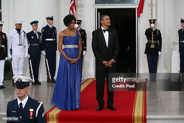 President Barack Obama and first lady Michelle Obama wait to greet Mexican President Felipe Calderon and his wife Margarita Zavala to the White House...