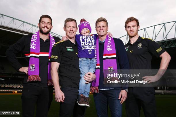 Bone Marrow Failure patient Elliott poses with Josh Bruce of the Saints Jack Riewoldt of the Tigers and his brother and St.Kilda Saints legend Nick...