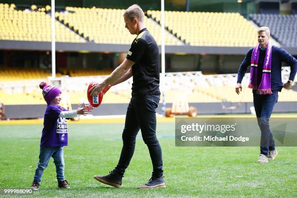 Bone Marrow Failure patient Elliott plays with Jack Riewoldt of the Tigers and his brother and St.Kilda Saints legend Nick Riewoldt during the...