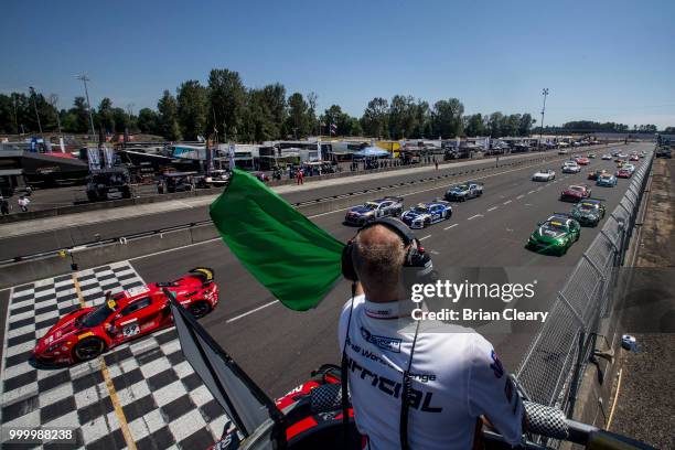 The green flag waves to start the Pirelli World Challenge race at Portland International Raceway on July 15, 2018 in Portland, Oregon.