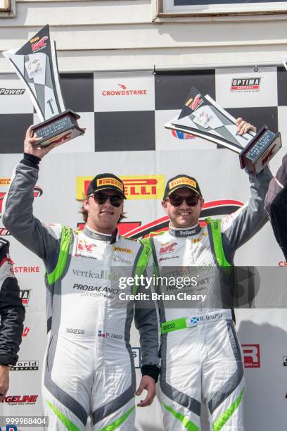 Parker Chase and Ryan Dalziel raise their trophies after the Pirelli World Challenge race at Portland International Raceway on July 15, 2018 in...
