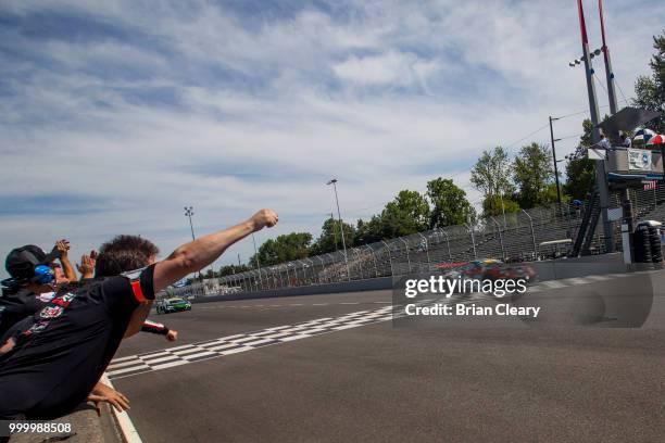 Crewmen celebrate as the checkered flag waves to end the Pirelli World Challenge race at Portland International Raceway on July 15, 2018 in Portland,...