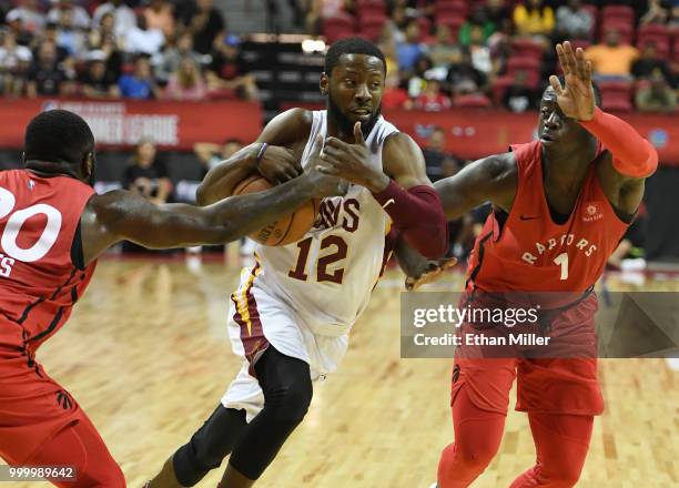 Scoochie Smith of the Cleveland Cavaliers drives between Giddy Potts and Rawle Alkins of the Toronto Raptors during a quarterfinal game of the 2018...