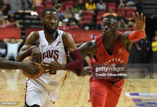 Scoochie Smith of the Cleveland Cavaliers drives against Rawle Alkins of the Toronto Raptors during a quarterfinal game of the 2018 NBA Summer League...