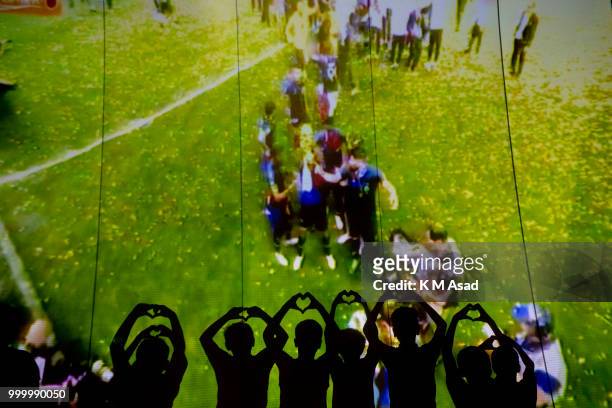 France wins the Russia 2018 FIFA World Cup and children celebrate this when they watch on a projector screen at the street in Dhaka.