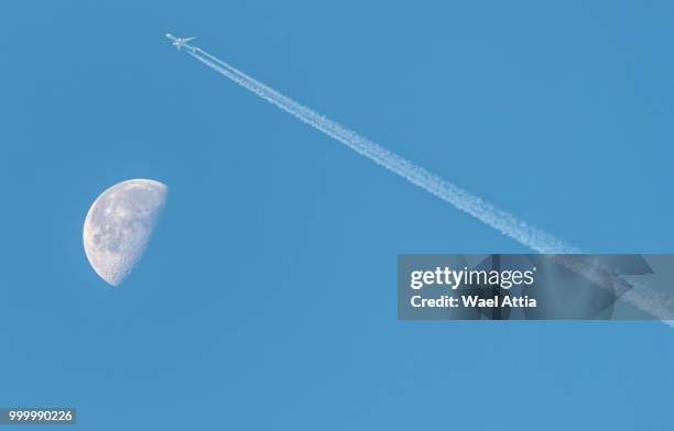 waning gibbous moon near last quarter, daytime shot with an aeroplane over the moon. - last fotografías e imágenes de stock