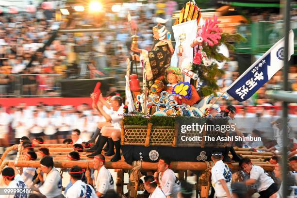 The seventh Nakasu Nagare members runs with float called 'Yamakasa' during the 'Oiyama' race through Seido Street of Kushidajinja Shrine during the...