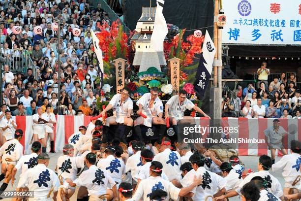 The sixth Higashi Nagare members runs with float called 'Yamakasa' during the 'Oiyama' race through Seido Street of Kushidajinja Shrine during the...