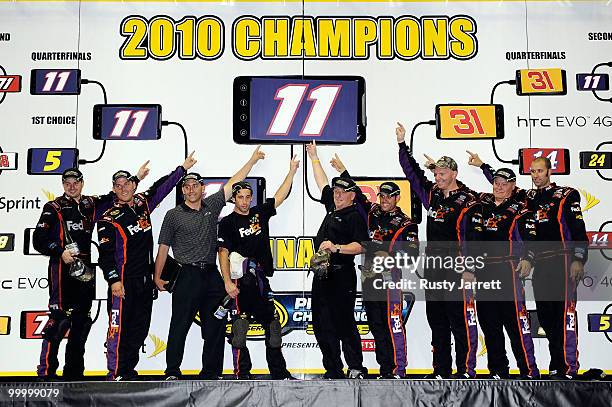The FedEx Freight Toyota pit crew pose after defeating the Caterpillar Chevrolet pit crew in the finals of the NASCAR Sprint Pit Crew Challenge at...