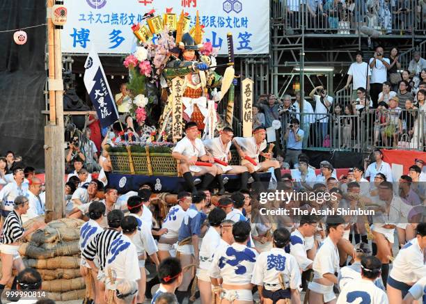 The fifth Daikoku Nagare members runs with float called 'Yamakasa' during the 'Oiyama' race through Seido Street of Kushidajinja Shrine during the...