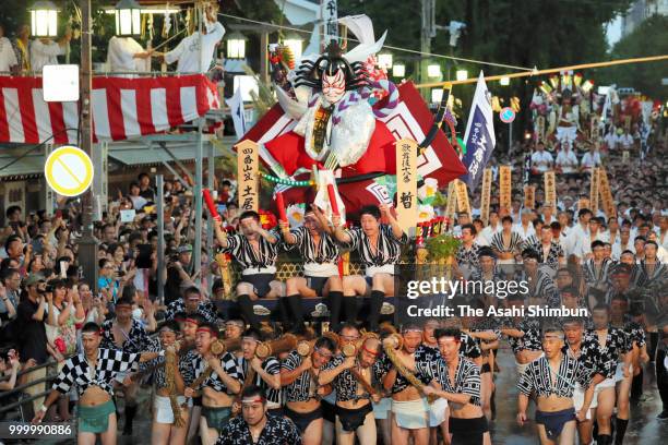 The fourth Doi Nagare members runs with float called 'Yamakasa' during the 'Oiyama' race through Seido Street of Kushidajinja Shrine during the...