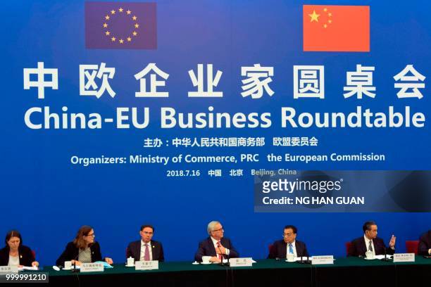 China's Premier Li Keqiang looks over to European Commission President Jean-Claude Juncker as they attend the China-EU Business Roundtable at the...