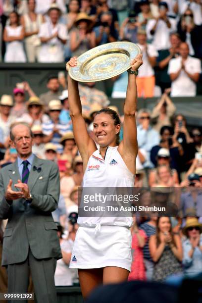 Angelique Kerber of Germany holds the Venus Rosewater Dish after defeating Serena Williams of The United States in the Ladies' Singles final on day...