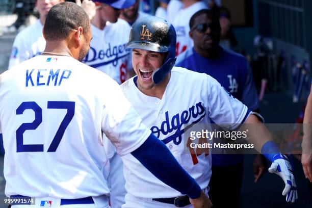 Enrique Hernandez of the Los Angeles Dodgers celebrates with Matt Kemp after hitting a solo homerun during the MLB game against the Los Angeles...