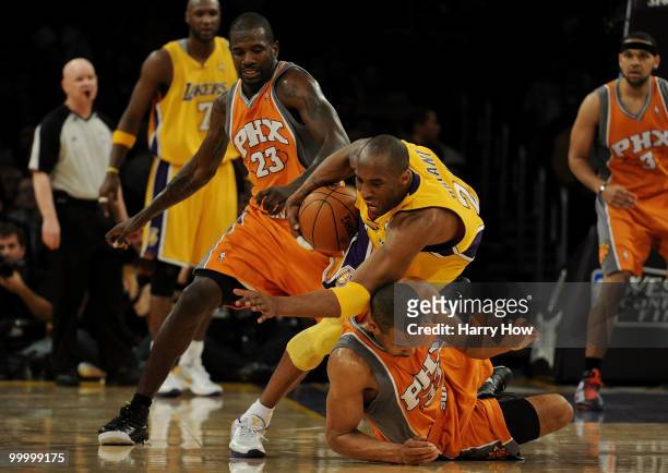 Kobe Bryant of the Los Angeles Lakers falls over Grant Hill of the Phoenix Suns in the first quarter of Game Two of the Western Conference Finals...