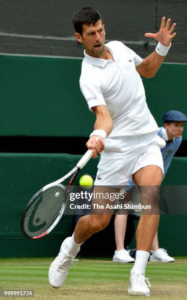 Novak Djokovic of Serbia plays a forehand against Rafael Nadal of Spain during their Men's Singles semi-final on day twelve of the Wimbledon Lawn...