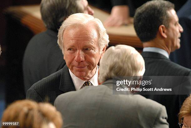 Senator Joe Lieberman, D-Conn talks with members on the house floor before Nuri al-Maliki, Prime Minister of Iraq, speaks to a joint session of...