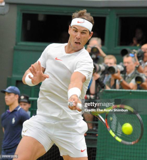 Rafael Nadal of Spain plays a forehand against Novak Djokovic of Serbia during their Men's Singles semi-final on day twelve of the Wimbledon Lawn...