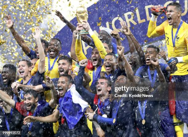 France goalkeeper Hugo Lloris raises the World Cup trophy as he celebrates with his teammates after beating Croatia 4-2 to win the country's second...