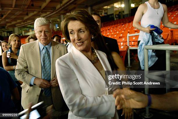 Rep. John Larsen-D, Conn, and House Majority Leader Nancy Pelosi, greet fans as they walk to their seats at RFK stadium, Pelosi's appearance wasn't...